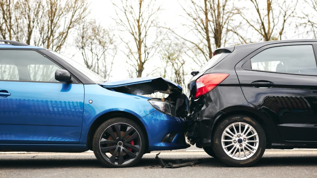 Can Accident Reimbursement Be Claimed? Image shows a car accident with a blue car and a black car colliding.