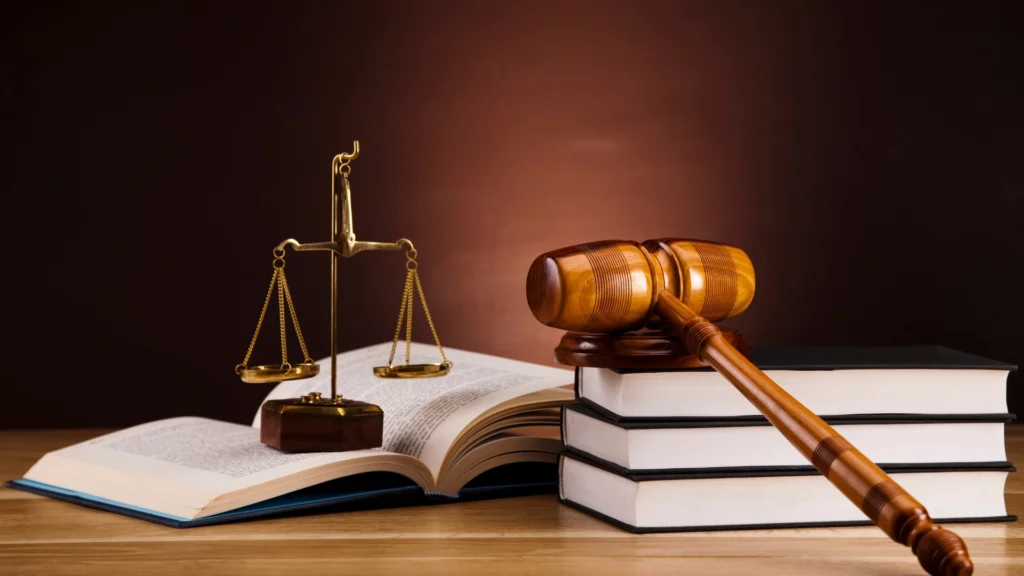 Law books, scales, and gavel representing legal help from a car accident attorney when no insurance is involved