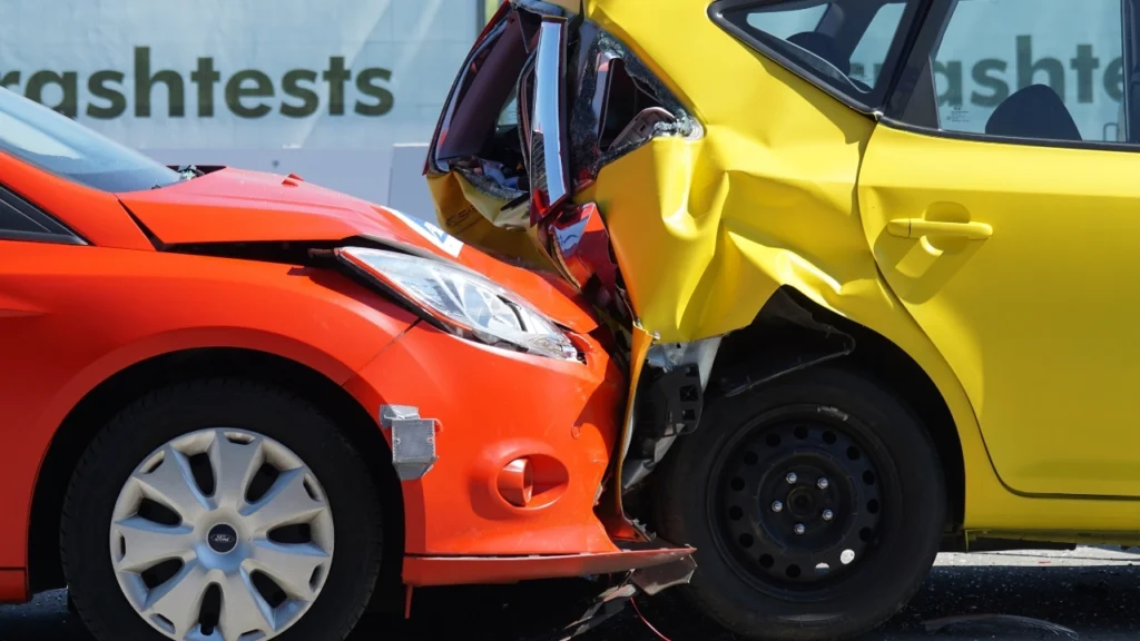 Rear-end crash between red and yellow cars used to ask, does health insurance cover car accidents and related injuries?