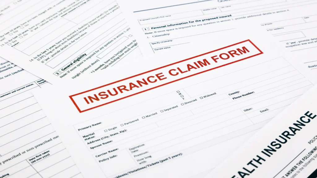 Close-up of insurance claim forms what happens if you don't use insurance money for repairs